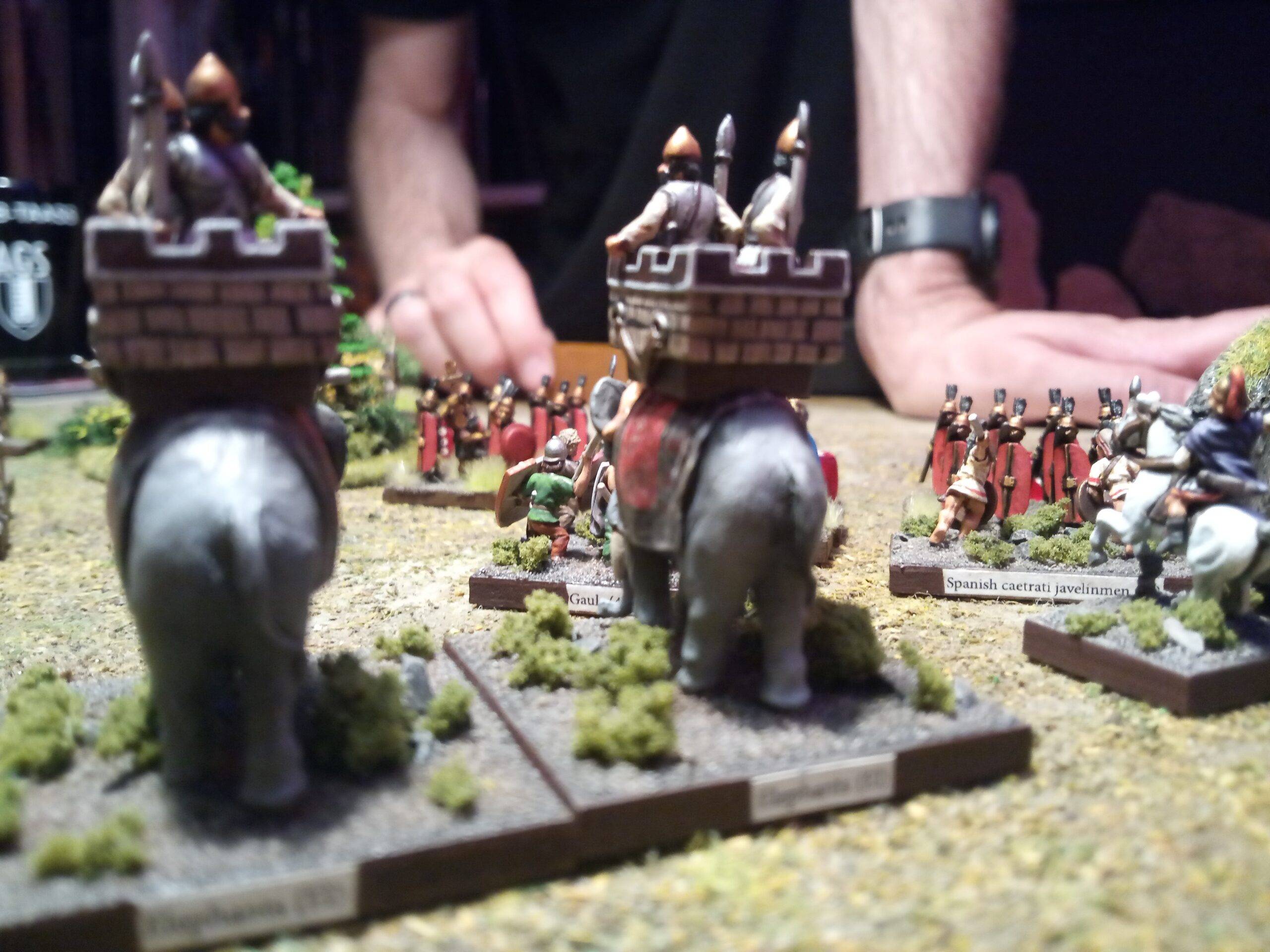 Kings of War Historical: Elephants getting ready for their turn after the Gaul Berserkers had a go at the heavily armored Roman Legions (R.I.P. Berserkers) . At their flank, the Carthaginian general is boosting the morale of his troops by being "inspiring".