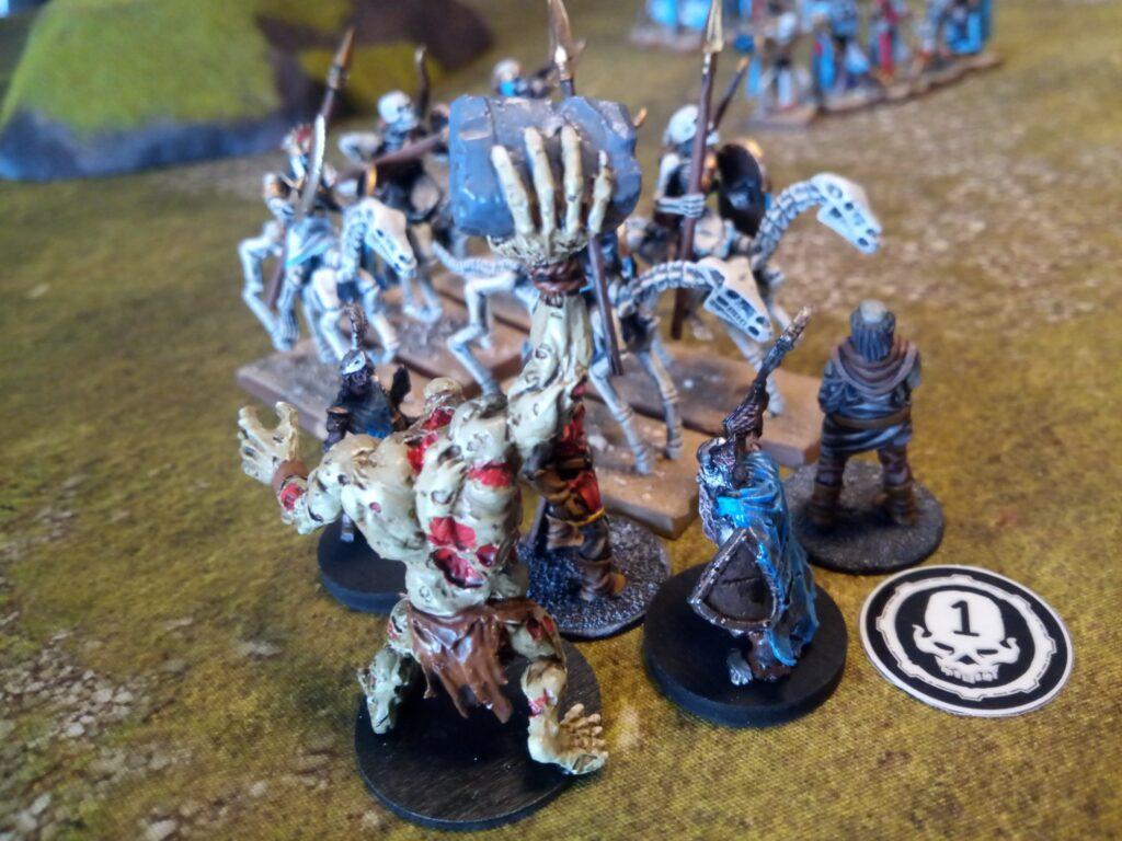 Mummified Undead rider being attacked by neutral zombies in the Danse Macabre scenario for One Page Rules Age of Fantasy.